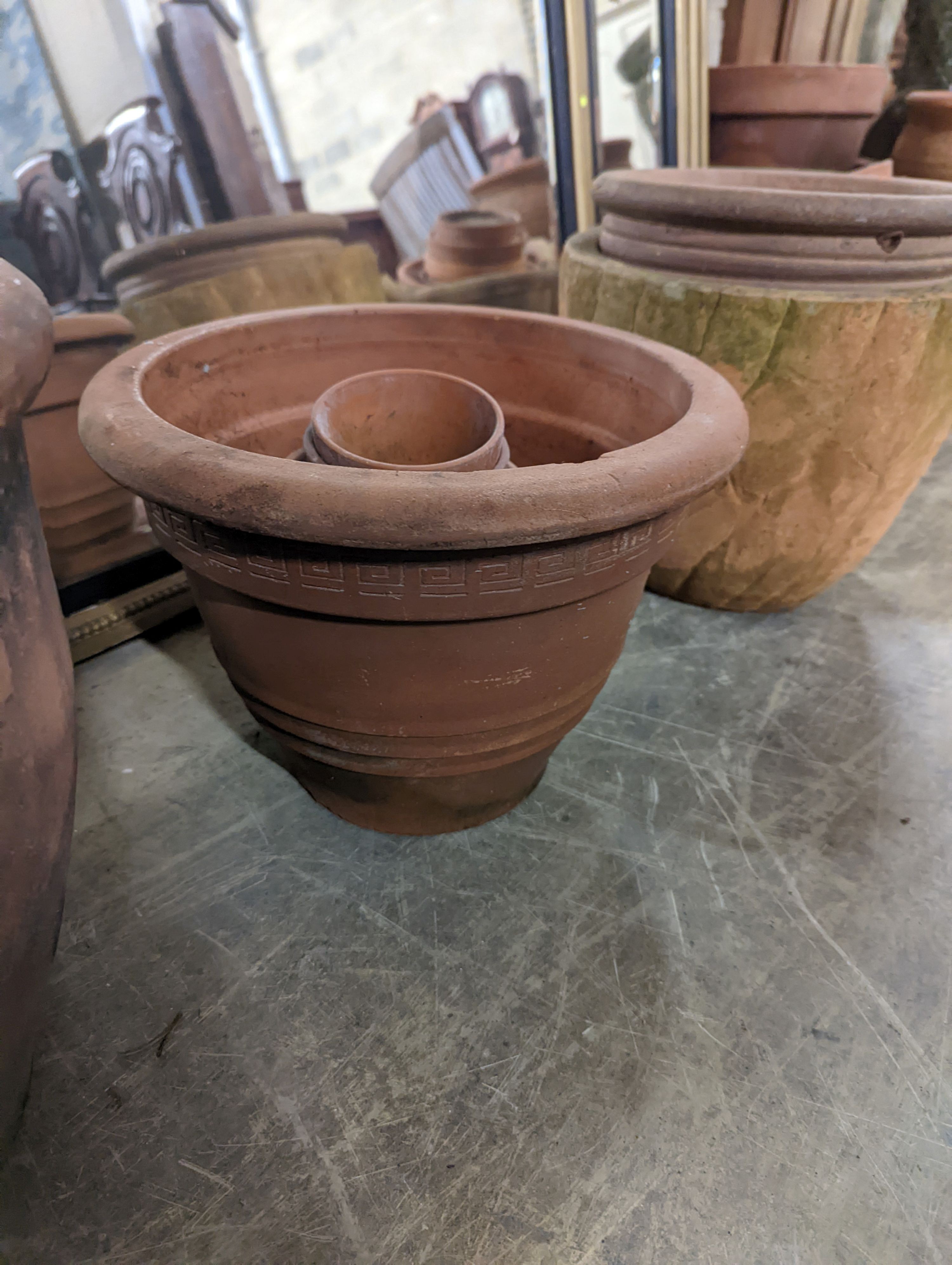 A collection of approximately 20 assorted terracotta garden planters, largest diameter 35cm